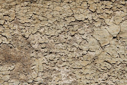 A wall loosing its paint in a small town in France.