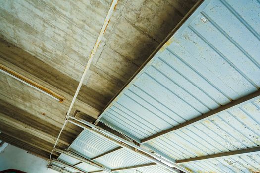 A industrial garage ceiling with open gates.