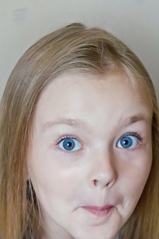 Photo of surprised cute girl with blond hair