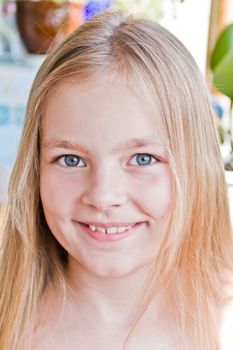 Cute girl with blond long hair and blue eyes