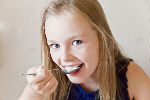 Photo of eating cute girl with blond hair