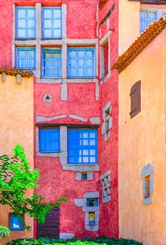 Detail of nice colorful wall with doors and windows, Sardinia, Italy