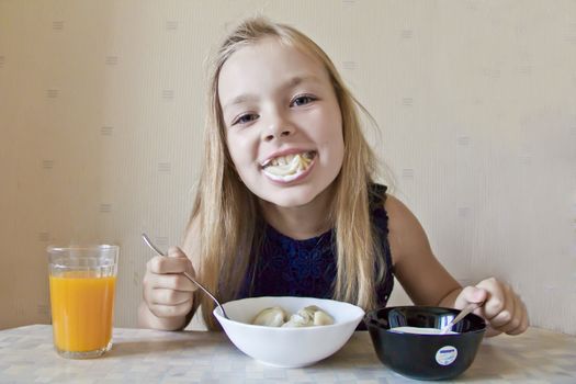 Photo of eating cute girl with blond hair