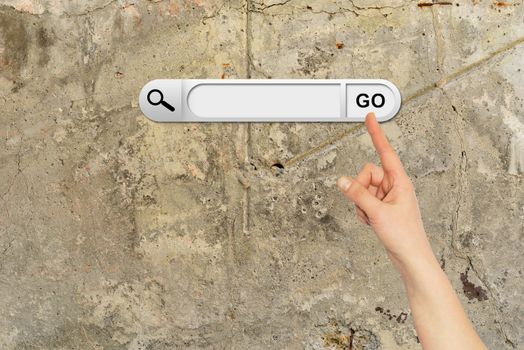 Human hand indicates the search bar in browser. Aged brown cemented floor on background