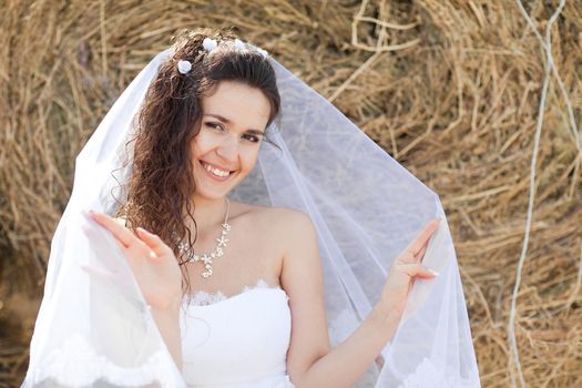 happy bride near hay