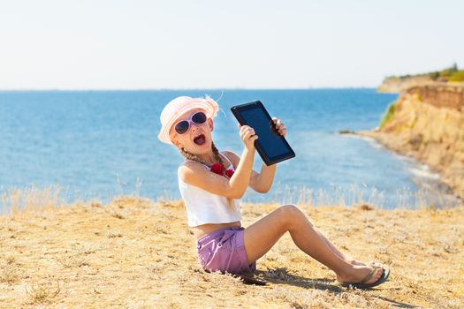 crying girl on the beach with laptop