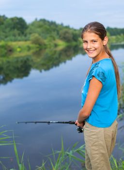 Summer vacation - Photo of cute girl fishing on the river.