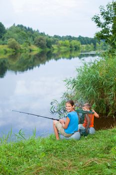 Summer vacation - Sister and brother fishing at the river