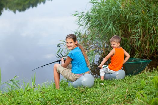 Summer vacation - Sister and brother fishing at the river