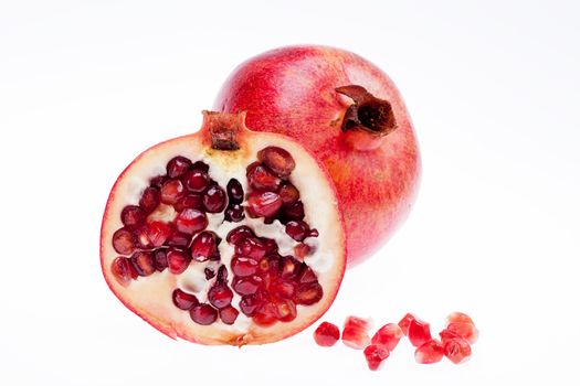 sectioned pomegranate isolated on white background