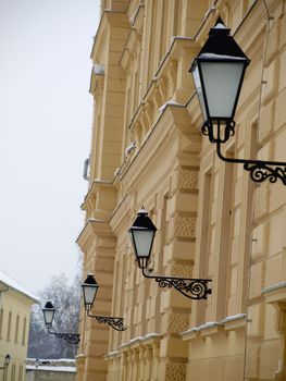 yellow building with windows and street lamp    