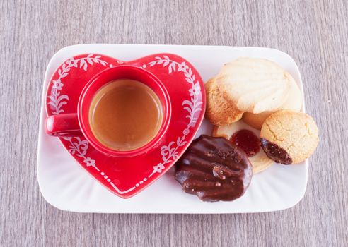 Coffee on red cup with different kind of biscuits