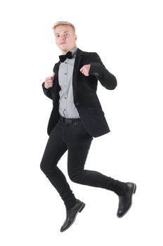 Handsome man in jacket and bow-tie jumping, isolated