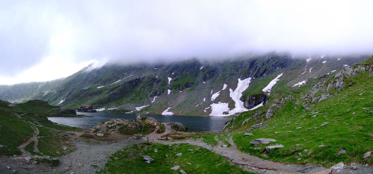 Balea Lake in the clouds and snow near transfagarasan road