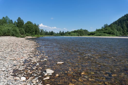 The mountain river with rapid current