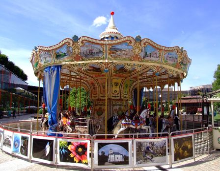 Carousel in Iasi Romania in the summer with blue sky behind