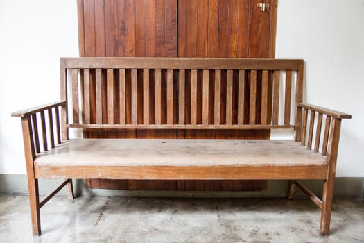 Front view of old wood bench in front of door