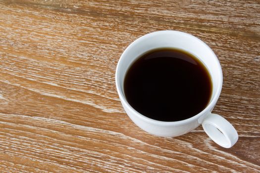 White cup of coffee on wooden table