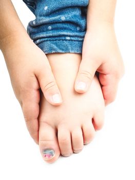 Girl holding onto her foot with a blue nail on the big toe after injury