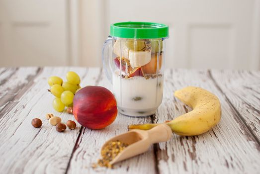 healthy organic fruit and nuts smoothie on wooden board