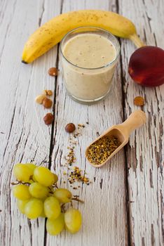 healthy organic fruit and nuts smoothie on wooden board