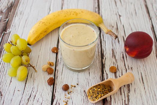 healthy organic fruit and nuts smoothie on wooden board