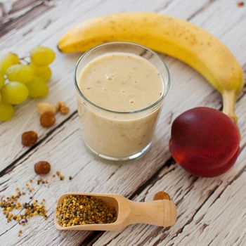 healthy organic fruit and nuts smoothie on wooden board