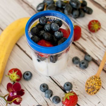 healthy organic fruit and nuts smoothie on wooden board