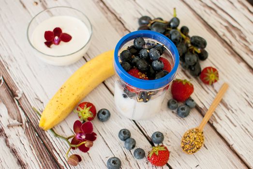 healthy organic fruit and nuts smoothie on wooden board