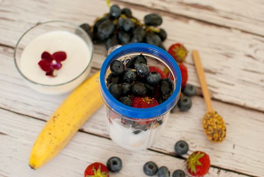 healthy organic fruit and nuts smoothie on wooden board