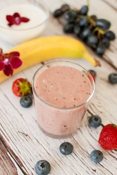 healthy organic fruit and nuts smoothie on wooden board