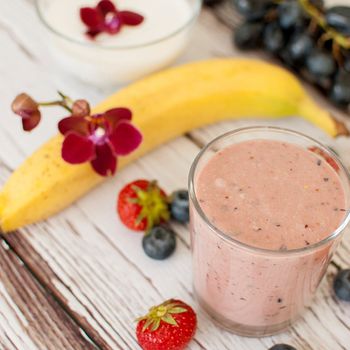 healthy organic fruit and nuts smoothie on wooden board