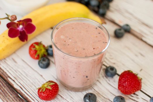 healthy organic fruit and nuts smoothie on wooden board