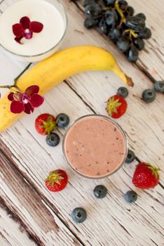 healthy organic fruit and nuts smoothie on wooden board