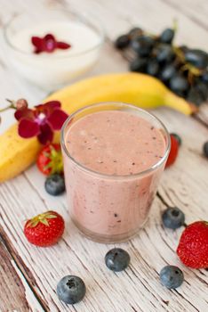 healthy organic fruit and nuts smoothie on wooden board