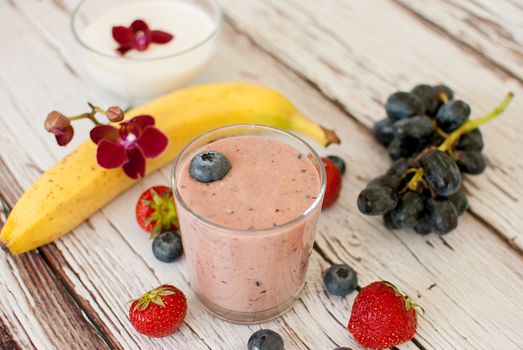 healthy organic fruit and nuts smoothie on wooden board