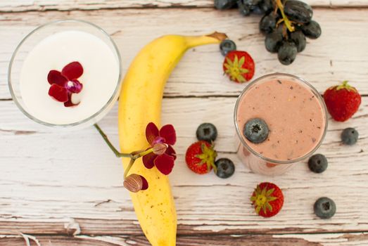 healthy organic fruit and nuts smoothie on wooden board