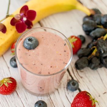 healthy organic fruit and nuts smoothie on wooden board