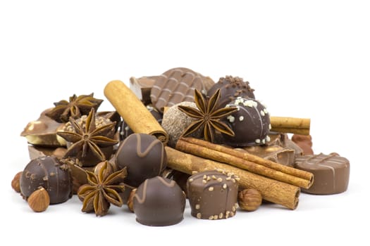 chocolate, spices and nuts on white background