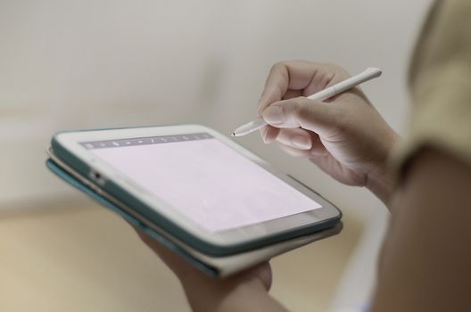 hand writing on a tablet