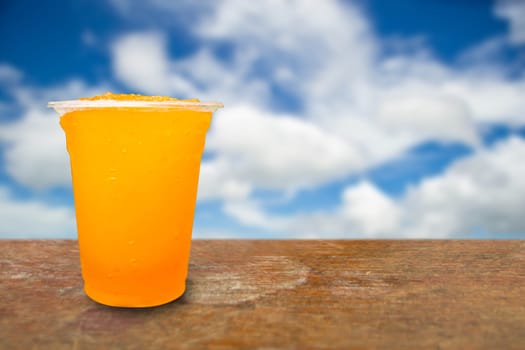 Orange juice in plastic cups on a background