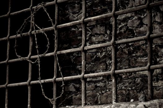 Burned up prison cell with barbed wire