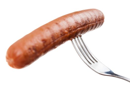 a delicious sausage on a fork over white