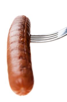 a delicious sausage on a fork over white