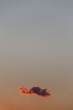 Single cloud on colourfull dusk sky. Copy space on top