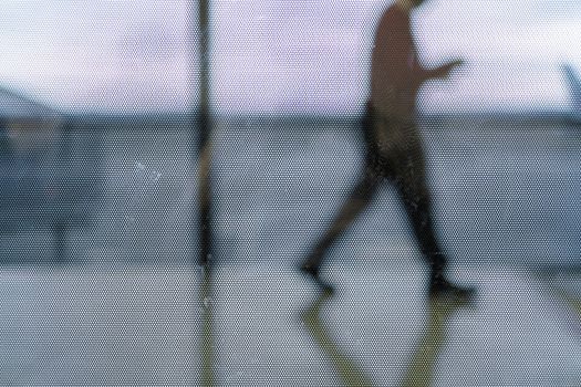 Cropped out of focus shot of passenger walking