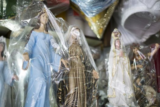BELO HORIZONTE, BRAZIL - JULY 28: Religious icons wrapped in plastic in Brazilian market. The saints are significant to Catholicism and African-Brazilian religions. July 28, 2014 in Belo Horizonte.