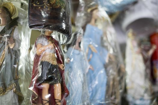 BELO HORIZONTE, BRAZIL - JULY 28: Religious icons wrapped in plastic in Brazilian market. The saints are significant to Catholicism and African-Brazilian religions. July 28, 2014 in Belo Horizonte.