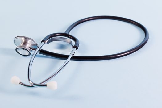 Stethoscope on light blue background