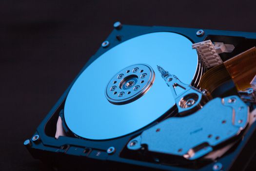 an opened hard disk on black background